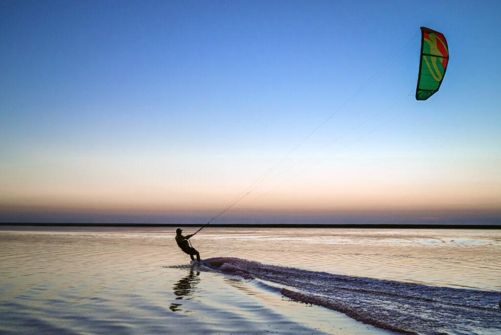Kite surfing on the shore of the pink lake. Kherson. Ukraine